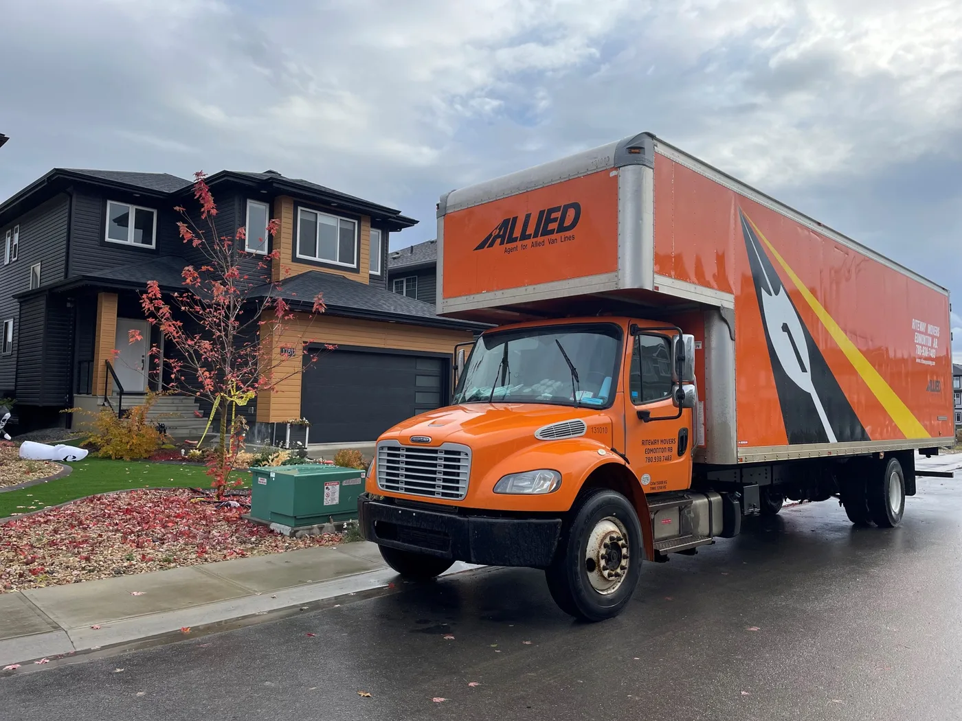 Allied Van Lines moving truck in an autumn neighborhood.