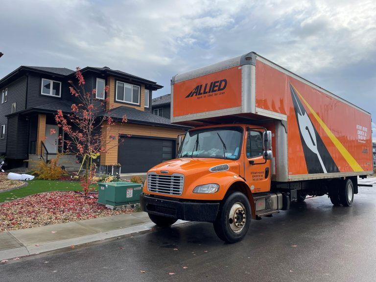 Riteway Allied moving truck parked outside a family home